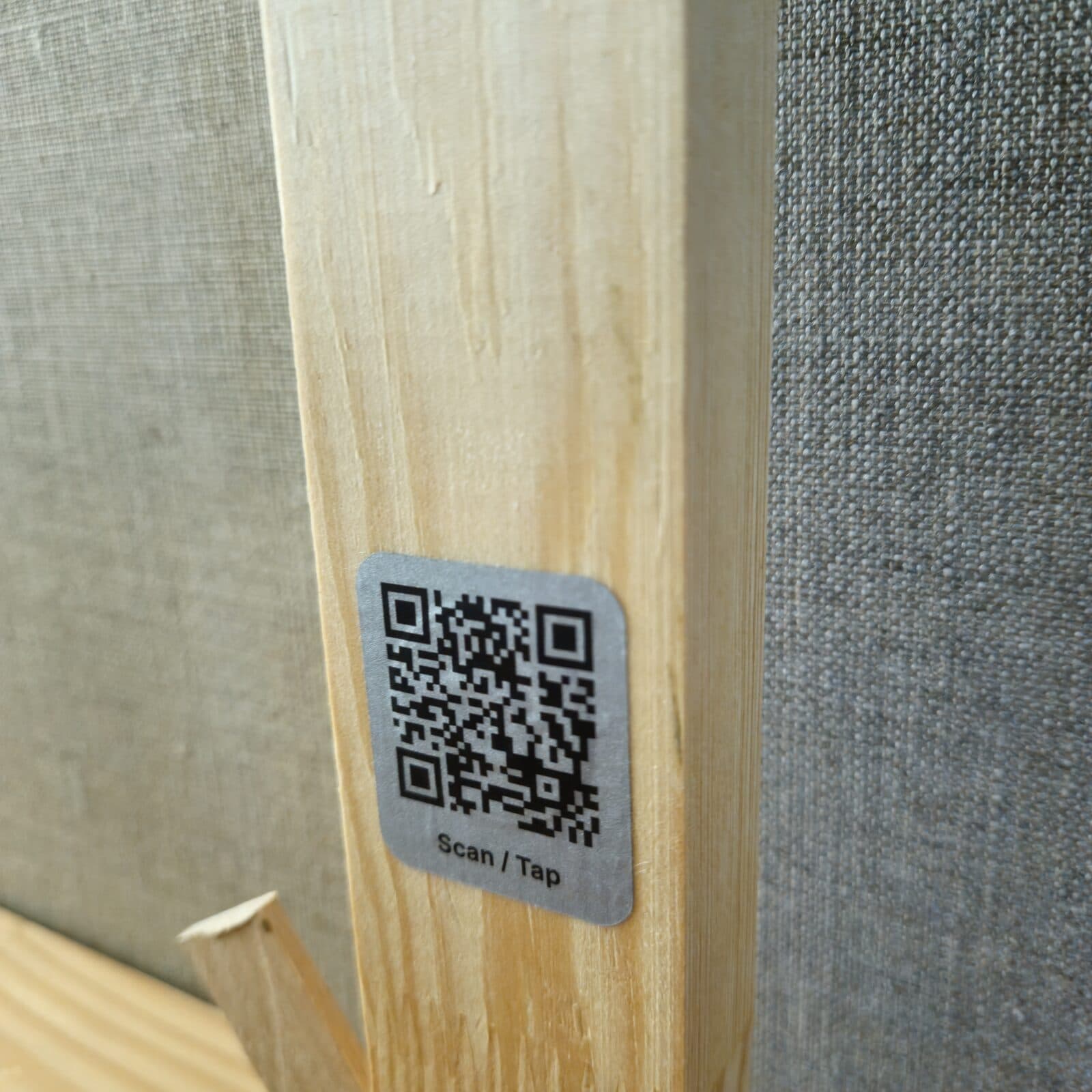 A QR story tag on the back of a physical painting